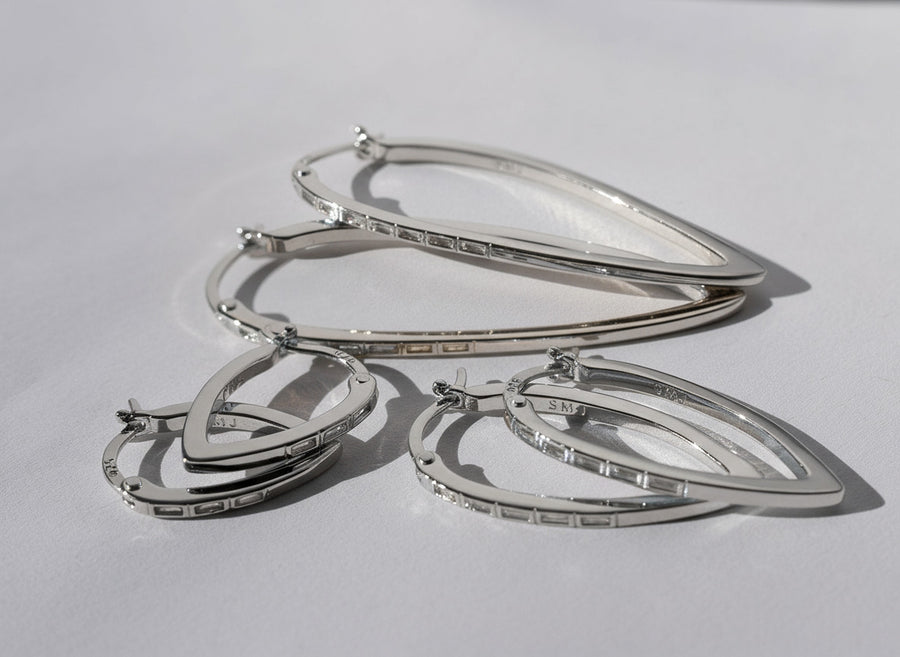 Silver hoop earrings on a light gray background
