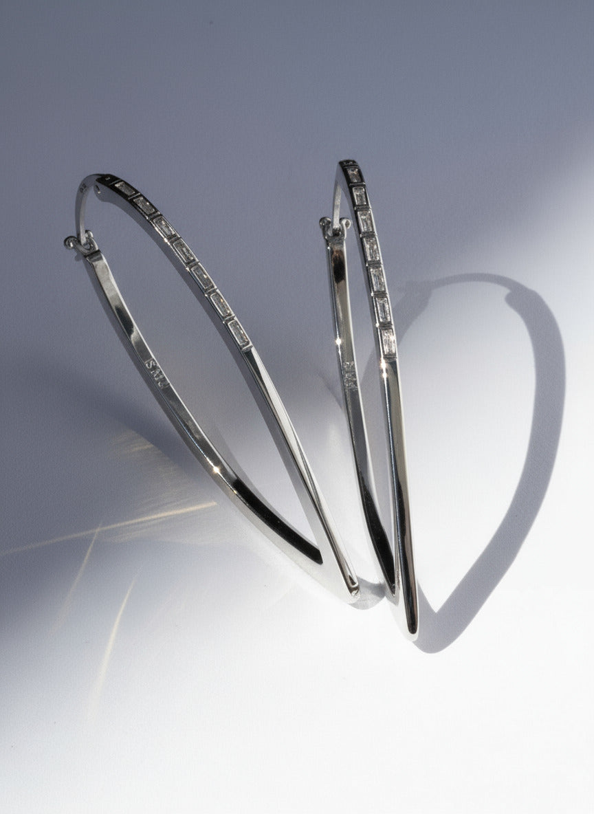 Silver hoop earrings on a light gray background