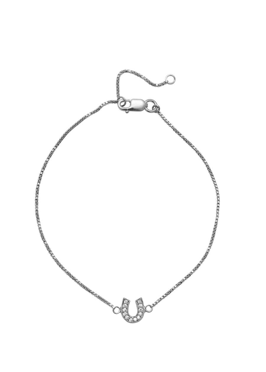 Silver bracelet with a horseshoe charm on a white background