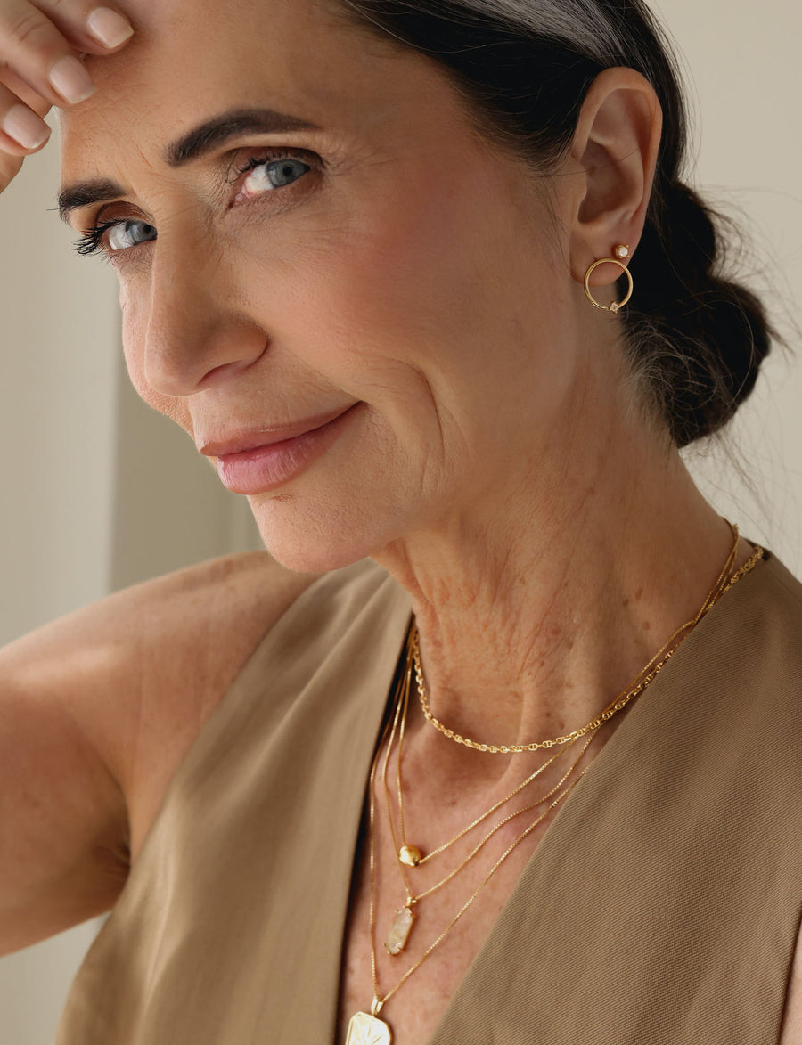 A model wearing a layer of old earrings
