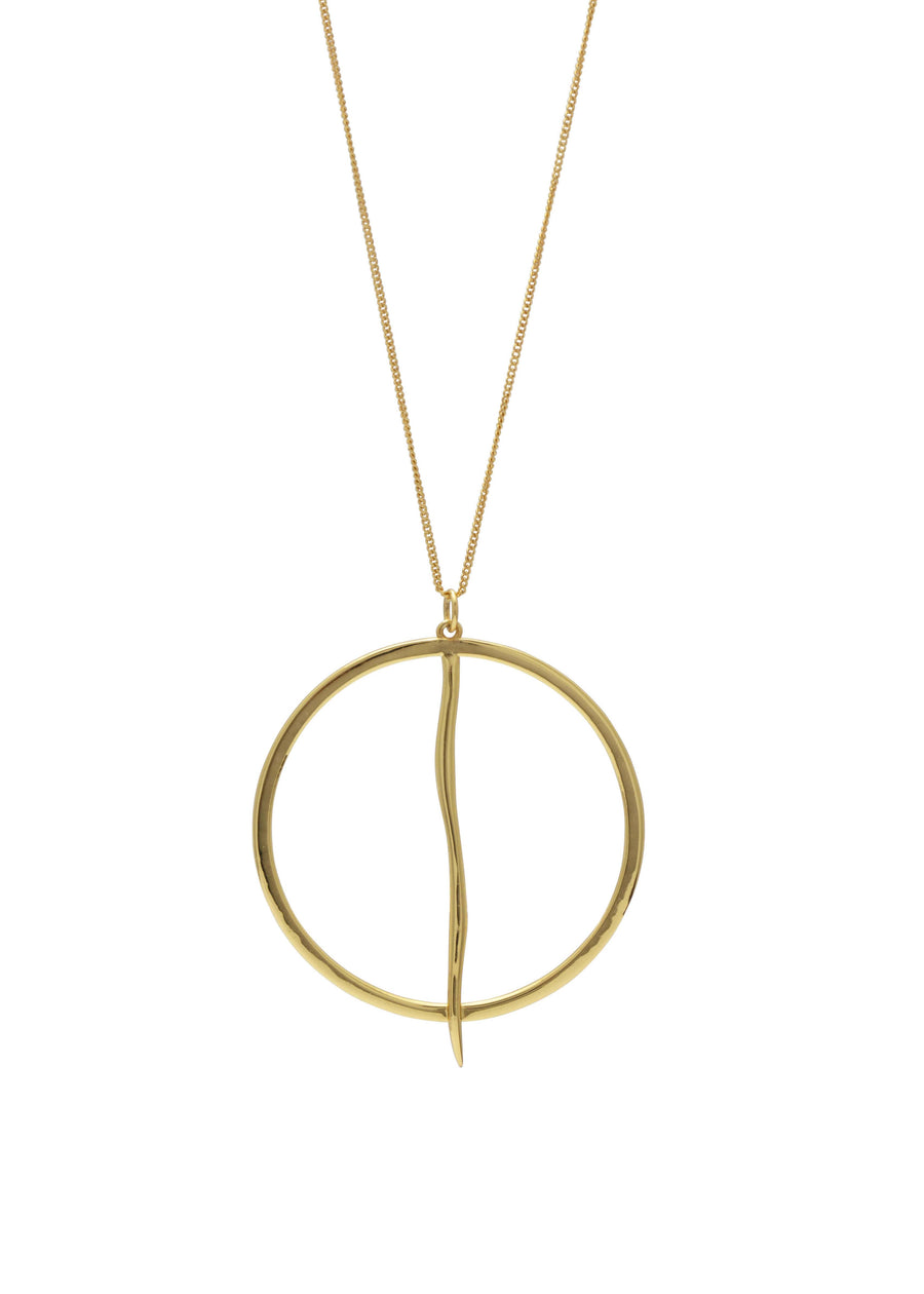 a contemporary gold necklace on a white backdrop