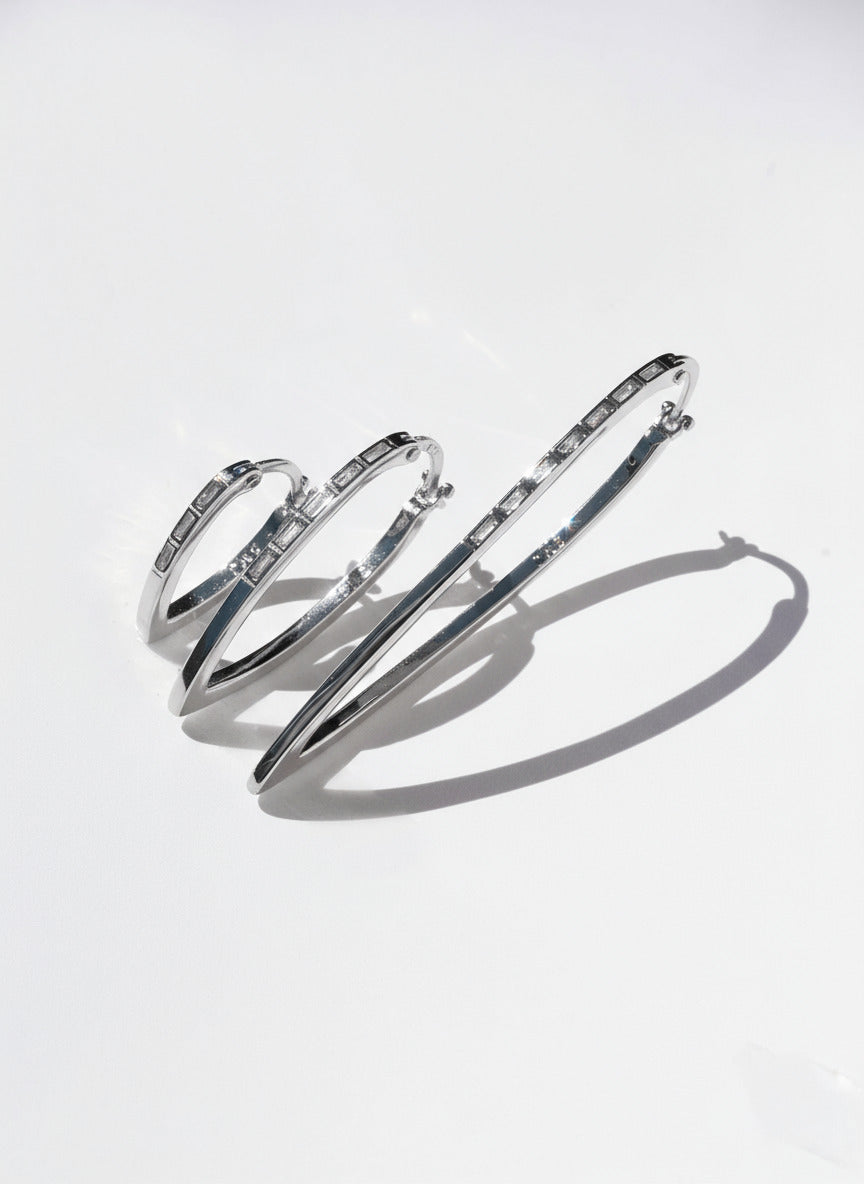 Silver hoop earrings on a light gray background
