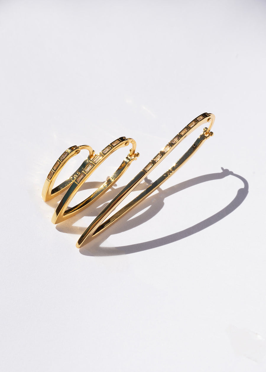 Gold hoops on a light gray background