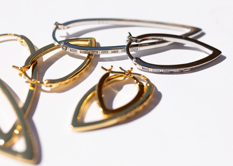 gold and silver hoop earrings on a white background