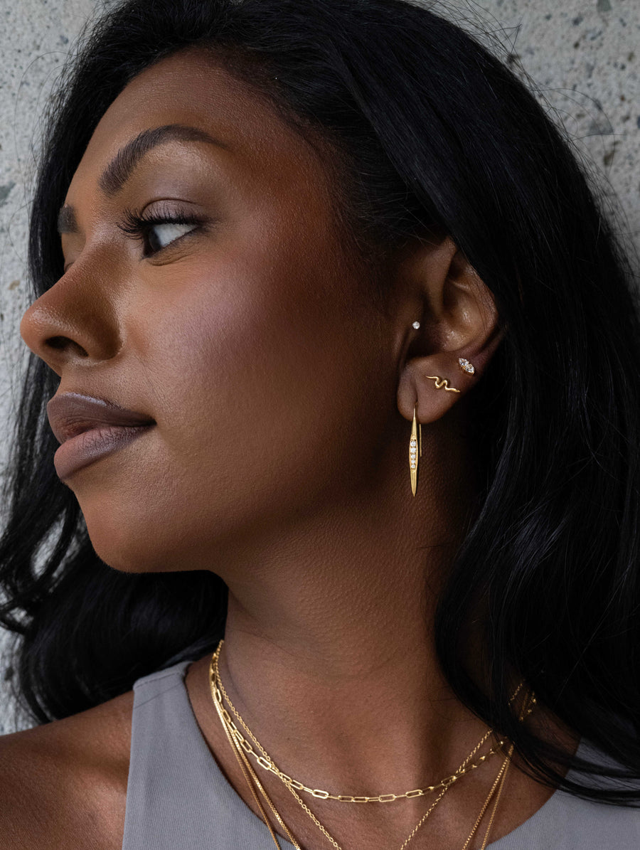 Sarah Mulder Jewelry layer of gold earrings stacked in 3 piercings on a model