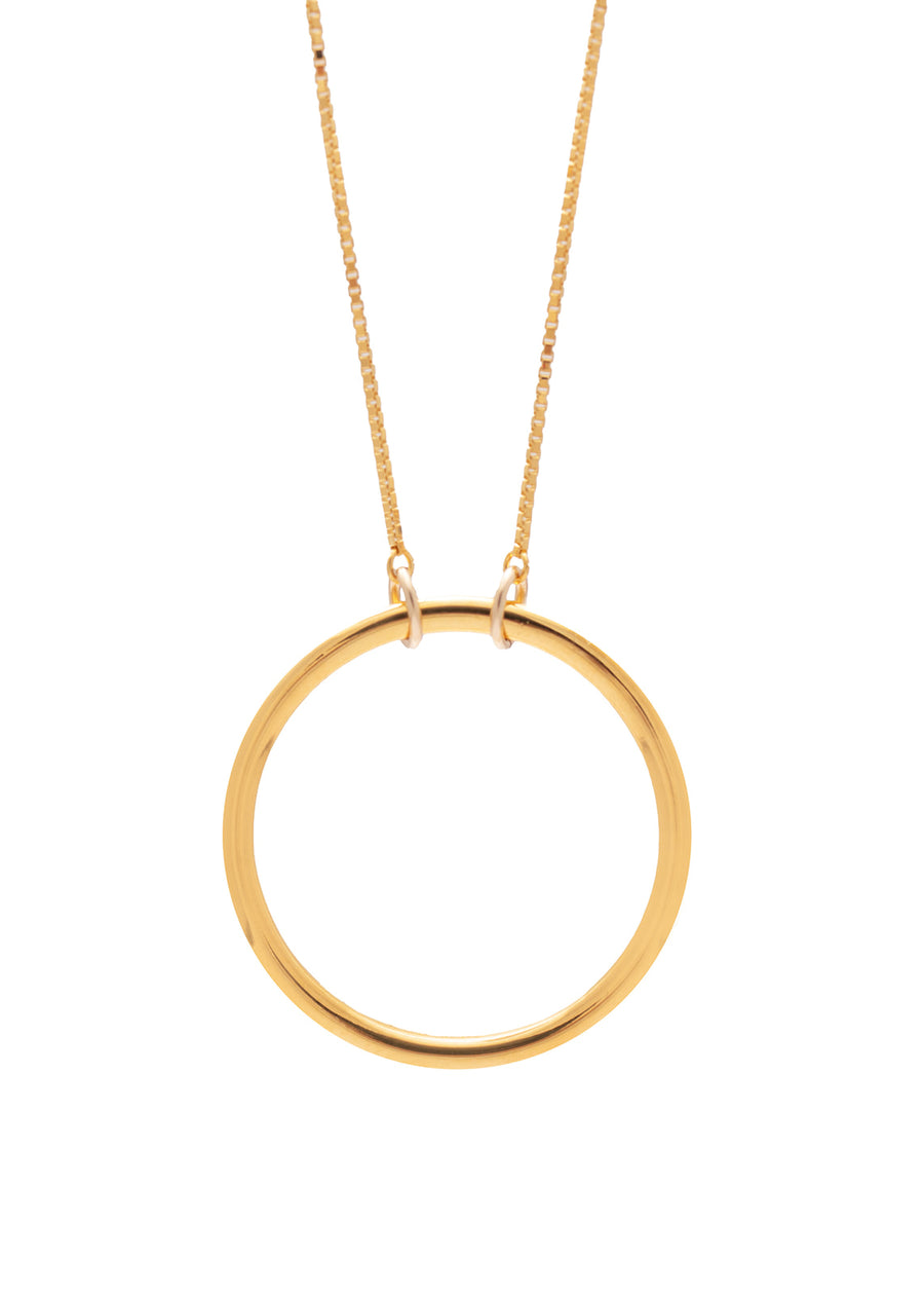 A gold necklace with a large ring