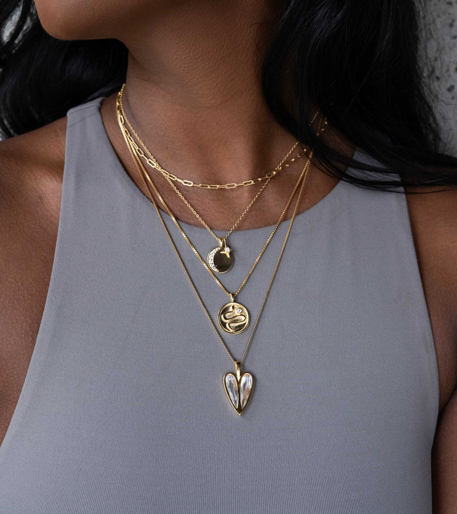 a stack of 4 gold necklaces by Vancouver designer Sarah Mulder