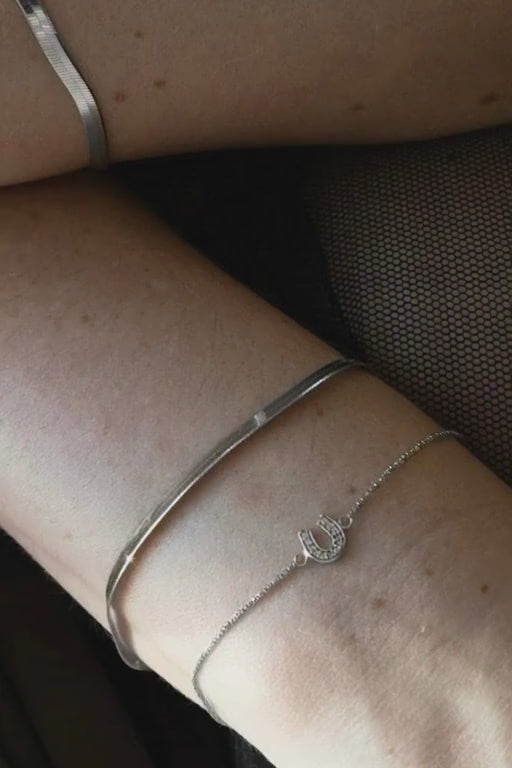Sarah Mulder Jewelry silver layering bracelets worn by a woman