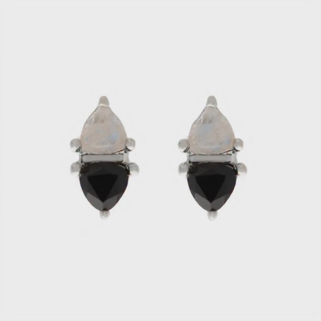 Moonstone and black onyx earrings turning slowly in a video on a white background
