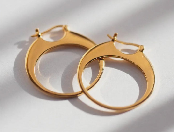 Sarah Mulder Jewelry designer hoops in gold on a white backdrop