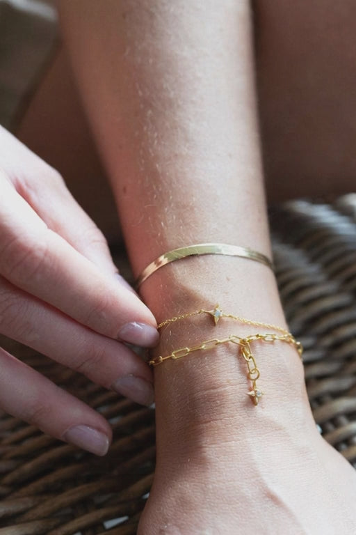 Sarah Mulder Jewelry layers of gold chain bracelets on a models arm