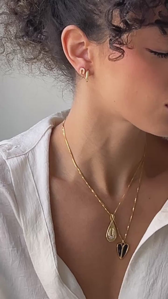 A model wearing a layer of gold jewelry by Vancouver designer Sarah Mulder