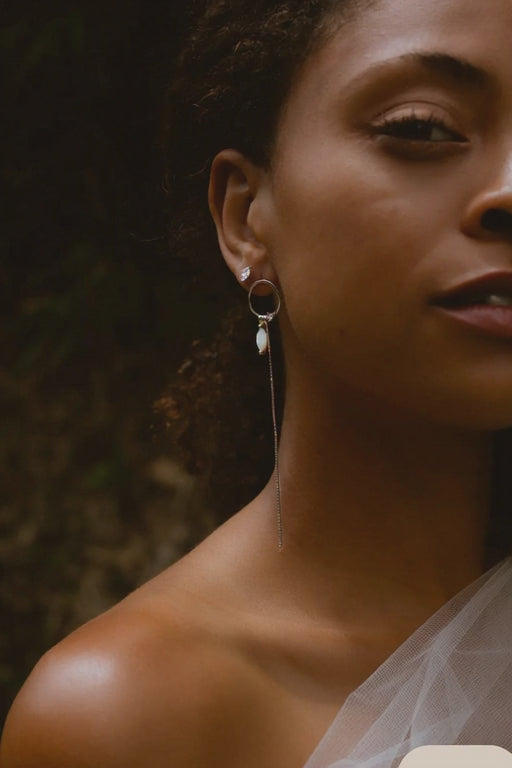 woman smiling and laughing wearing long earrings