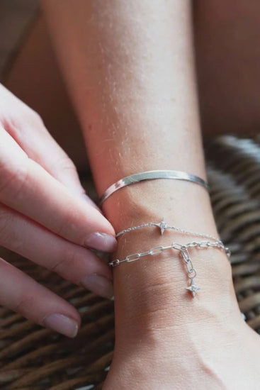 Sarah Mulder jewelry layers of silver chain bracelets worn by a model 