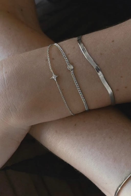 Sarah Mulder Jewelry layer of silver chain bracelets on a woman's arm