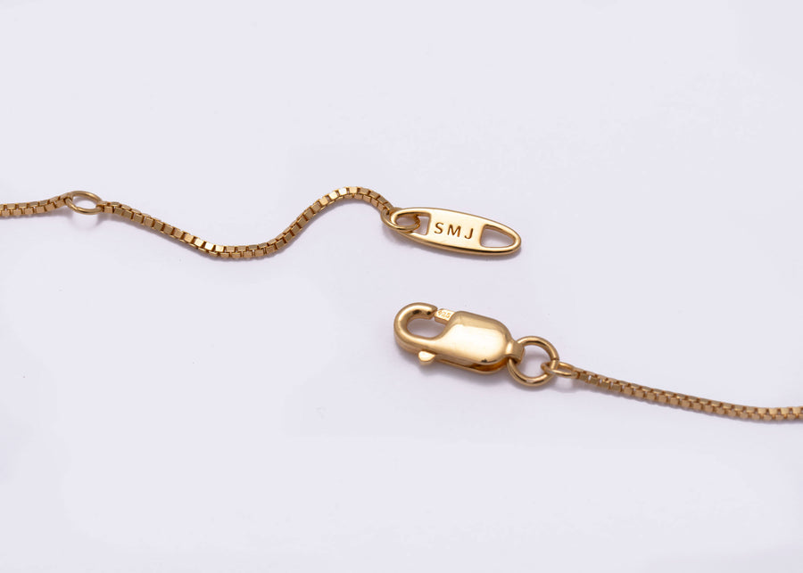 ends of necklace branded with SMJ