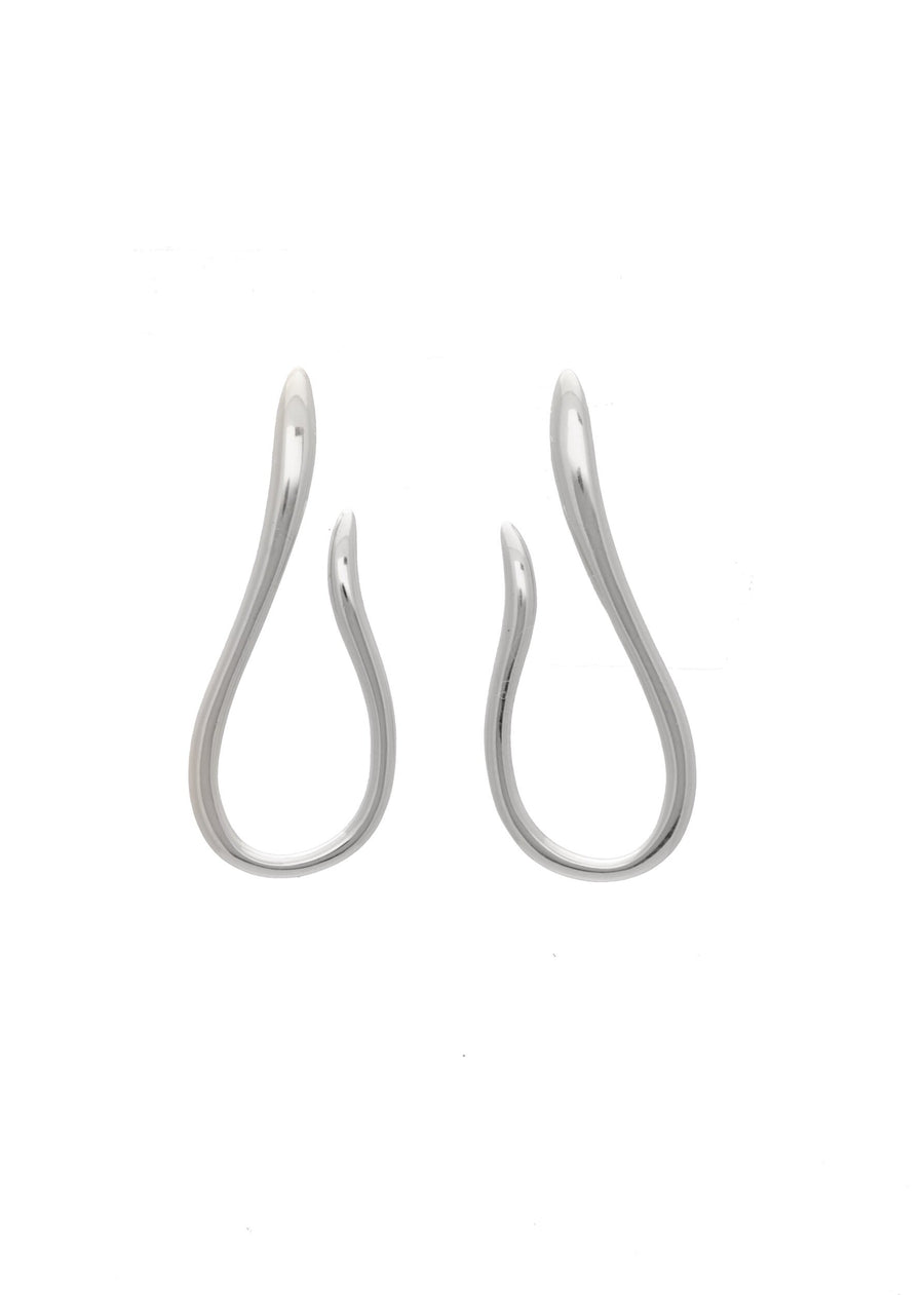 a pair of silver earrings in a fluid shape
