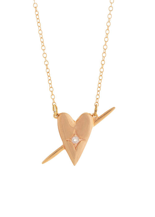 a gold heart necklace on a white background by designer Sarah Mulder