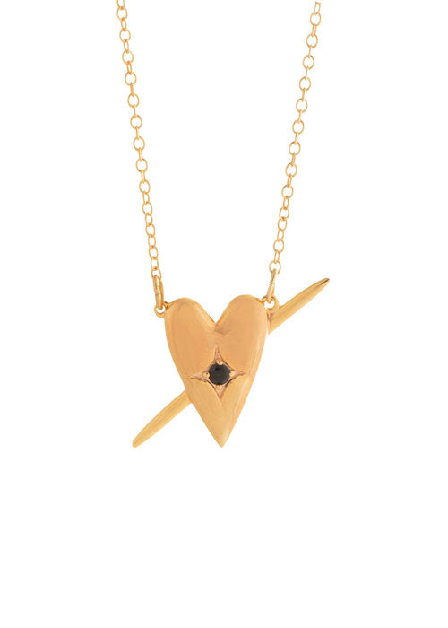 A gold-plated necklace with a heart-shaped pendant featuring a small faceted stone, displayed against a white background.